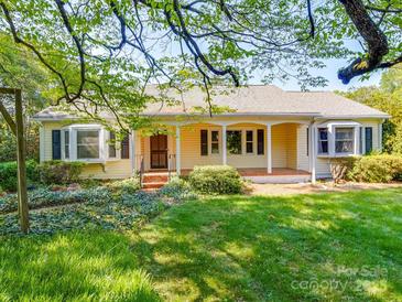 Inviting home with a quaint front porch and lush landscaping, set on a large grassy lot at 2326 Armstrong Cir, Gastonia, NC 28054
