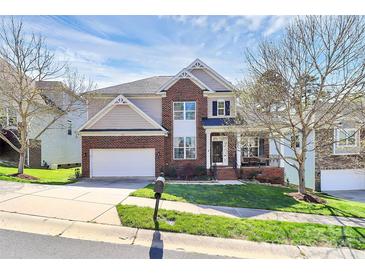 Inviting two-story home featuring a brick facade, manicured lawn, and a two-car garage at 2425 Orofino Ct, Charlotte, NC 28269