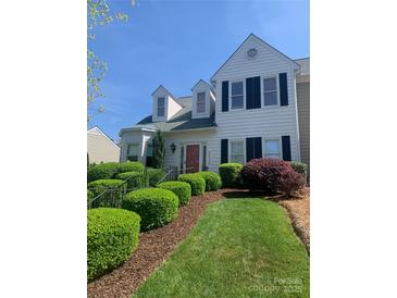 Charming two-story home with manicured lawn and beautiful landscaping, including lush green bushes at 2516 Middlebridge Ln, Charlotte, NC 28270
