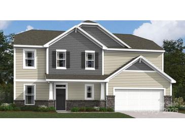 Charming two-story home featuring a mix of siding and stone accents, an attached two-car garage, and manicured landscaping at 274 Winford Rd, Troutman, NC 28116