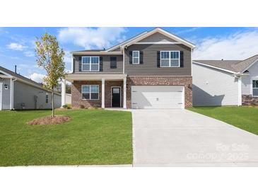 Charming two-story home with a brick and gray siding, a well-manicured lawn, and an attached two-car garage at 4610 Harris Elliot Rd, Lincolnton, NC 28092