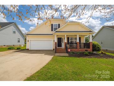 Charming two-story home featuring a welcoming front porch, attached garage and a well maintained lawn at 5015 Drake Pond Ln, Rock Hill, SC 29732