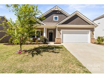 Charming single-Gathering home featuring a two-car garage and landscaped front yard at 7633 Tanglewood Way, Denver, NC 28037