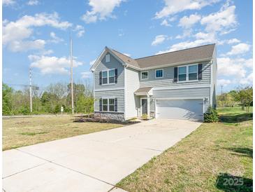 Charming two-story home featuring a long driveway, attached garage, and manicured front lawn at 101 Glencroft Dr, Wingate, NC 28174