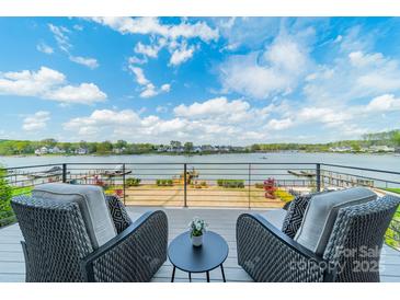 Outdoor balcony showcasing the waterfront view with comfortable seating to relax and enjoy the scenery at 139 Little Indian Loop, Mooresville, NC 28117