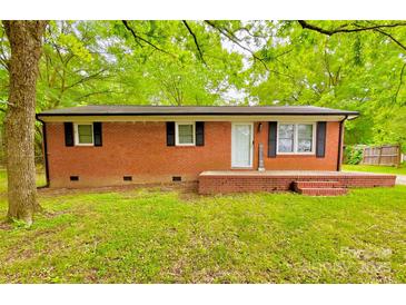 Charming brick home featuring a welcoming front porch and a classic, clean design at 1780 Short St, Mount Pleasant, NC 28124