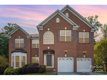 Lovely two-story brick home featuring manicured landscaping, attached two car garage and classic shutters at 1801 Briarcrest Nw Dr, Charlotte, NC 28269