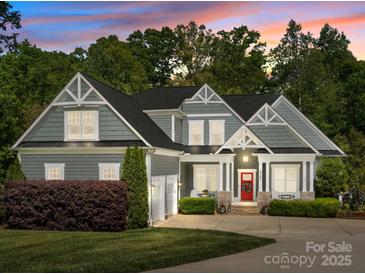 Charming two-story home with gray siding, white trim, a red front door, and a well-manicured front yard at 6743 Fox Ridge Cir, Davidson, NC 28036