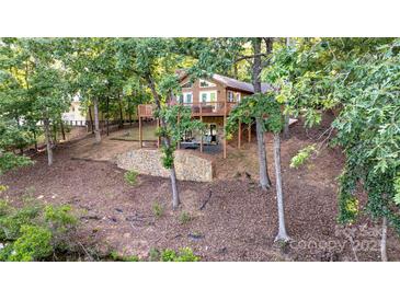 Beautiful home featuring a deck, lower patio, and lake views at 119 Harbor Ln, Mount Gilead, NC 27306