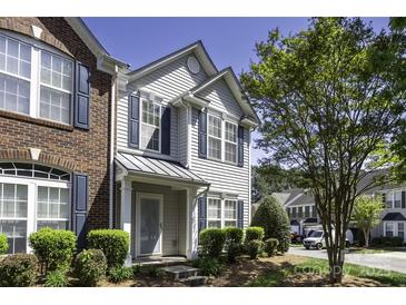 Charming townhouse featuring a blend of brick and siding, complemented by well-maintained landscaping and a welcoming entrance at 121 Talbert Town Loop, Mooresville, NC 28117