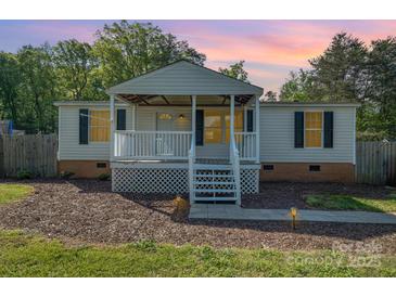 Charming single-story home features a cozy front porch perfect for enjoying peaceful evenings at 140 Misty Ln, Rockwell, NC 28138