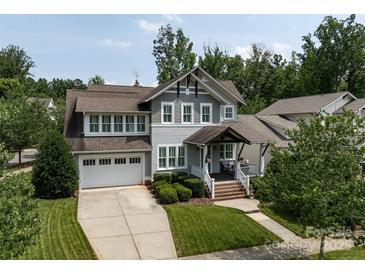 Charming home with a two-car garage, well-manicured lawn, and covered front porch at 1550 Matthew Mcclure Cir, Davidson, NC 28036