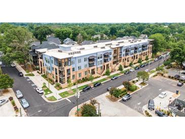 A modern apartment complex with blue and beige exterior and well-maintained landscaping at 2401 Euclid Ave, Charlotte, NC 28203