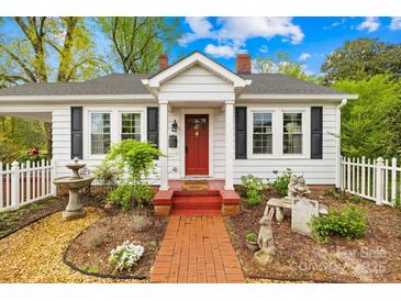 Charming home with a red brick walkway, delightful landscaping, and a bright red front door at 292 Mocksville Hwy, Statesville, NC 28625