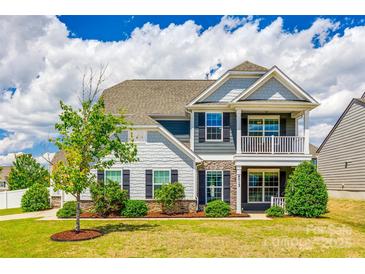 Charming two-story home with a well-manicured lawn, stone accents, and inviting front porch and balcony at 4013 Highgate Ln # 2B-78, Lancaster, SC 29720