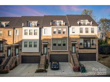 Beautiful townhome with brick accents, attached garages, and individual staircases leading to private entrances at 11039 Stetler St, Charlotte, NC 28204