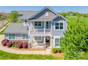 Charming two-story home boasts a welcoming front porch and a second-story balcony at 14905 Skyscape Dr, Huntersville, NC 28078