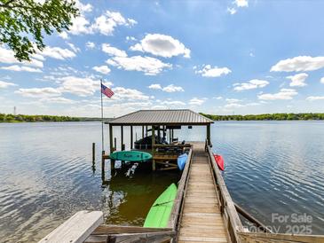 Waterfront dock featuring boat storage, a walkway, and an American flag at 2045 Manila Bay Ln, Tega Cay, SC 29708