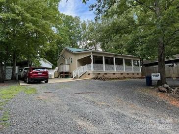 Charming home with a covered front porch, ample parking, and mature trees at 207 Deer Park Rd, Mount Gilead, NC 27306