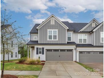 Charming townhome with a well-manicured lawn and a two-car garage provides appealing curb appeal at 23112 Clarabelle Dr, Charlotte, NC 28273