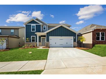Beautiful two-story home with a two-car garage, well-manicured lawn and a charming exterior at 2573 Blue Sky Meadows Dr, Monroe, NC 28110