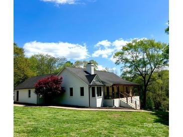 Charming one-story home boasts a welcoming porch and a lush, landscaped yard at 3032 Mckinney Rd, Shelby, NC 28152