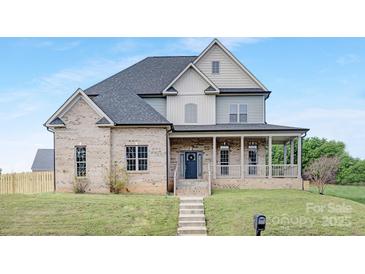 Charming two-story brick home with a welcoming front porch and well-manicured lawn at 4036 Meadowview Hills Dr # 7, Charlotte, NC 28269