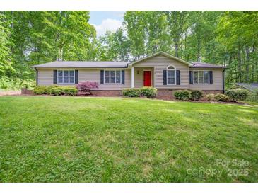 Charming single story home featuring a well-manicured lawn and a welcoming red front door at 4256 Wood Forest Dr, Rock Hill, SC 29732