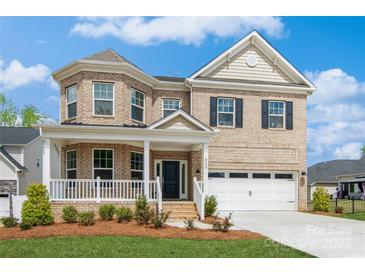 Beautiful two-story brick home featuring a welcoming front porch and well-manicured lawn at 620 Baneberry Bluff Ct, Rock Hill, SC 29732