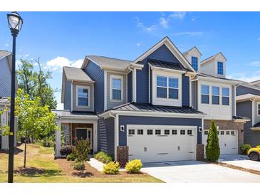 Charming two-story home featuring a two-car garage, blue siding, and a well-manicured front lawn at 637 Amber Meadows Way, Fort Mill, SC 29708