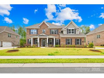 Beautiful brick home with a manicured front yard and inviting entrance at 705 Brown Creek Dr, Matthews, NC 28104