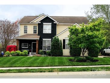 Charming two-story home with a well-manicured lawn and mature landscaping, presenting a welcoming curb appeal at 8140 Laurel Run Dr, Charlotte, NC 28269