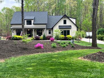 Charming home with a manicured lawn and landscaping, highlighting curb appeal and a welcoming entrance at 2656 Lee Lawing Rd, Lincolnton, NC 28092