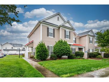Charming townhome with well-maintained lawn and landscaping, showcasing curb appeal and inviting entrance at 4133 Carl Parmer Dr, Harrisburg, NC 28075