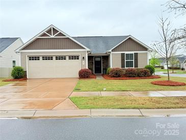 Charming single-story home with manicured lawn and attached two-car garage at 531 Cherry Blossom Nw Ave, Concord, NC 28027