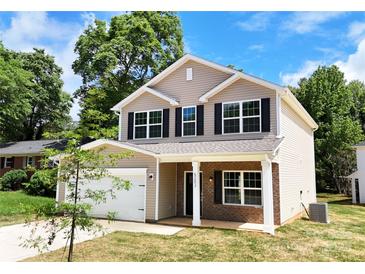 Charming two-story home with a well-manicured lawn and a two-car garage on a sunny day at 6219 Rockwell W Blvd, Charlotte, NC 28269