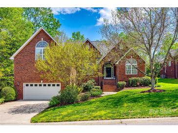 Charming brick home with a well-maintained front yard and a two car garage at 1126 Blowing Rock Cv, Fort Mill, SC 29708