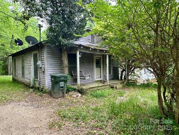 Exterior view of a home with a covered porch and mature trees at 267 Hall Nw Ave, Concord, NC 28027