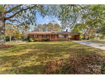 Charming brick ranch-style home with a covered carport and well-maintained front yard and mature trees at 3320 28Th Ne St, Hickory, NC 28601