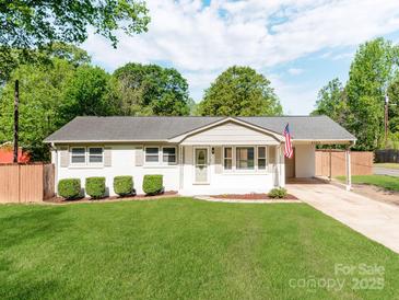 Charming single-story home with a well-manicured lawn and classic white exterior at 4303 Greenhaven Ln, Gastonia, NC 28056