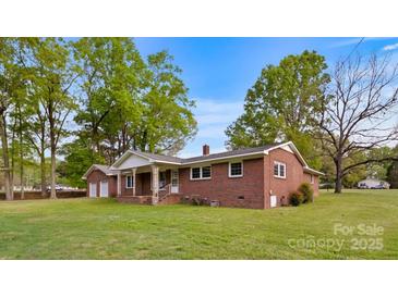 Charming brick home with a well-manicured lawn and mature trees, creating a welcoming curb appeal at 101 Stoneybrook Dr, York, SC 29745
