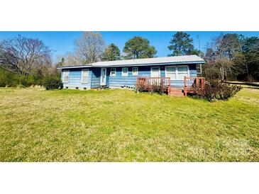 Charming blue home with a metal roof and a cozy red front porch at 1043 Sid Davis Rd, Chester, SC 29706