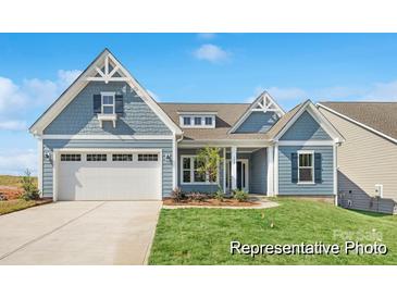 Charming craftsman-style home featuring a spacious two-car garage and manicured front yard at 1303 Links Crossing Dr # 219, Monroe, NC 28112