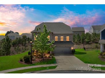 Charming two-story brick home with a well-manicured lawn and attached two-car garage at 17712 Yarwill Ct, Charlotte, NC 28278