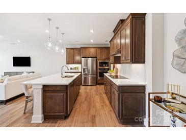 Modern kitchen features a large center island, stainless steel appliances, and sleek countertops at 217 Halemarg Dr, Belmont, NC 28012