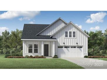 Charming new construction single-Gathering home showcasing a modern farmhouse design, a garage and a well-manicured lawn at 4154 Eastover Glen Rd # 0324, Charlotte, NC 28269
