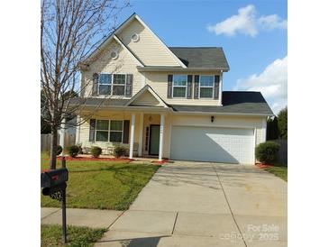 Charming two-story home boasts a well-manicured lawn, a spacious driveway, and an attached two-car garage at 464 Laurel Fork Dr, Fort Mill, SC 29715