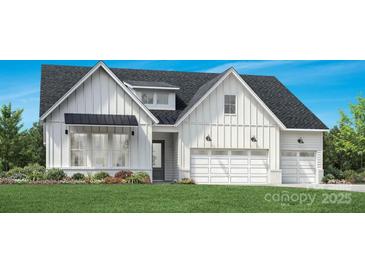 Charming white farmhouse featuring vertical siding, black roof, and a spacious two-car garage at 5300 Mint Harbor Way # 0286, Charlotte, NC 28269