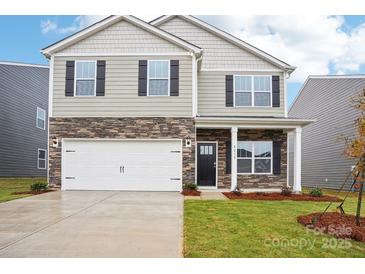 Charming two-story home with a two-car garage, stone accents, and a well-manicured lawn at 8059 Plymouth Dr, Sherrills Ford, NC 28673