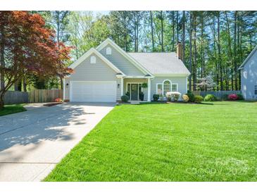 Charming single-story home with manicured lawn, two-car garage, and inviting front entrance at 8707 Copenhagen Ln, Charlotte, NC 28216